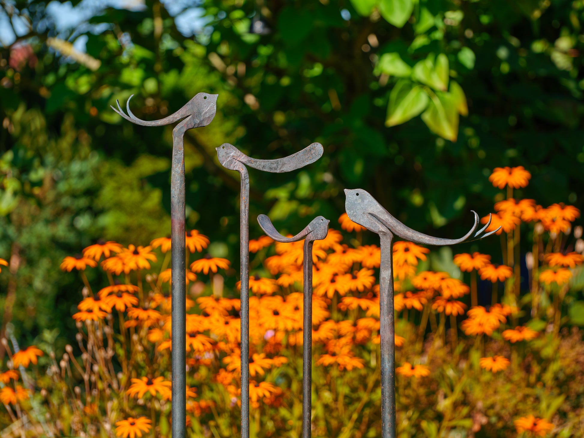geschmiedete Deko Garten metallvögel dekorativ zwischen Blumen